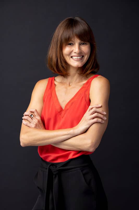 professional headshot taken in Sydney of lady in red top with arms folded