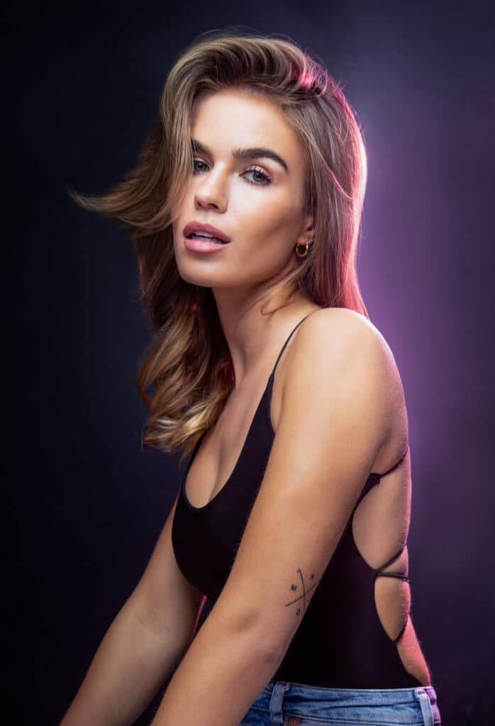 professional headshot of female model with purple backlight