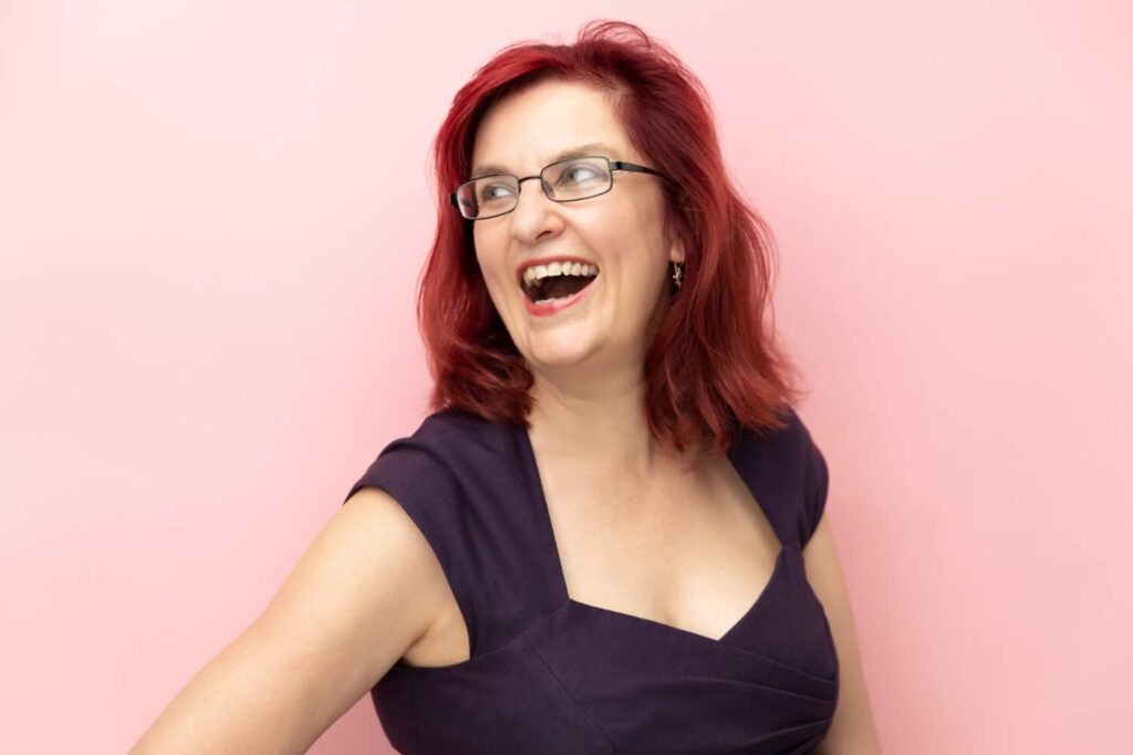 professional laughing headshot on pink background by hero shot photography