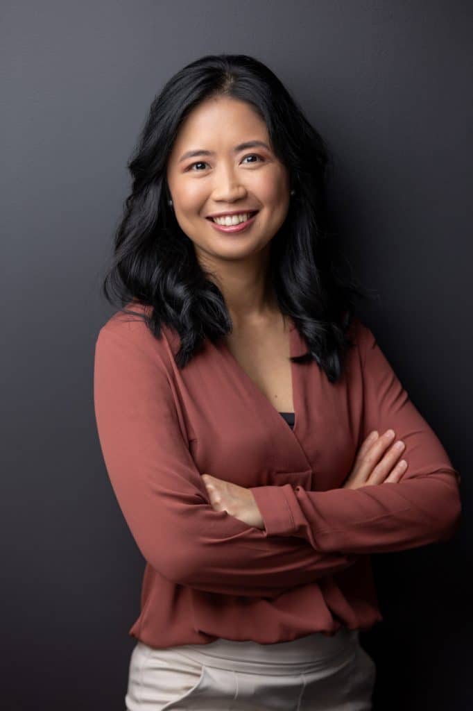 professional headshot of lady with black hair crossing arms