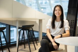 Asian female sitting for a professional headshot in an office